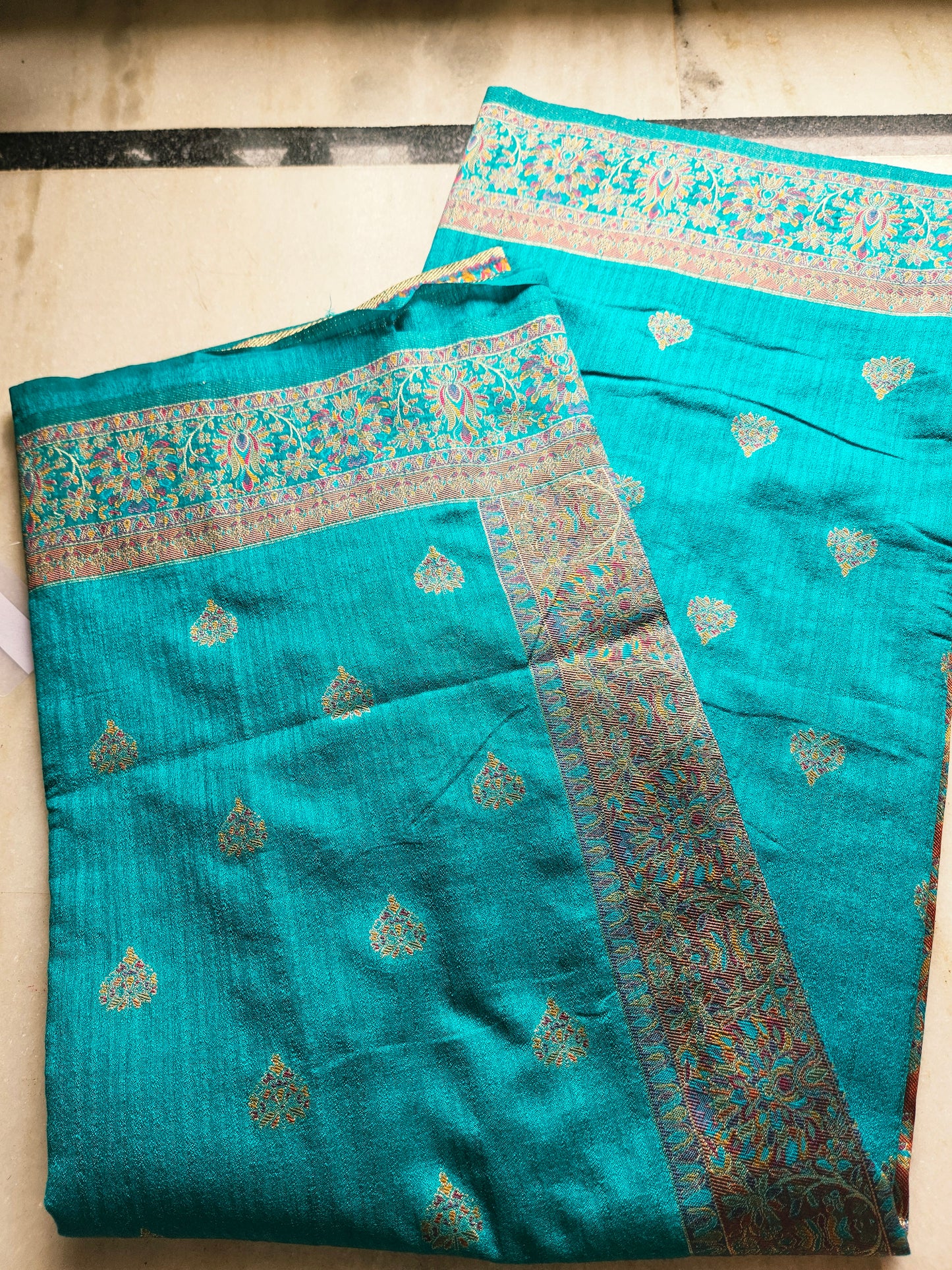 Premium Khaddi Silk Saree in Turquoise with Zari Buttis & Multicolor Kani Border