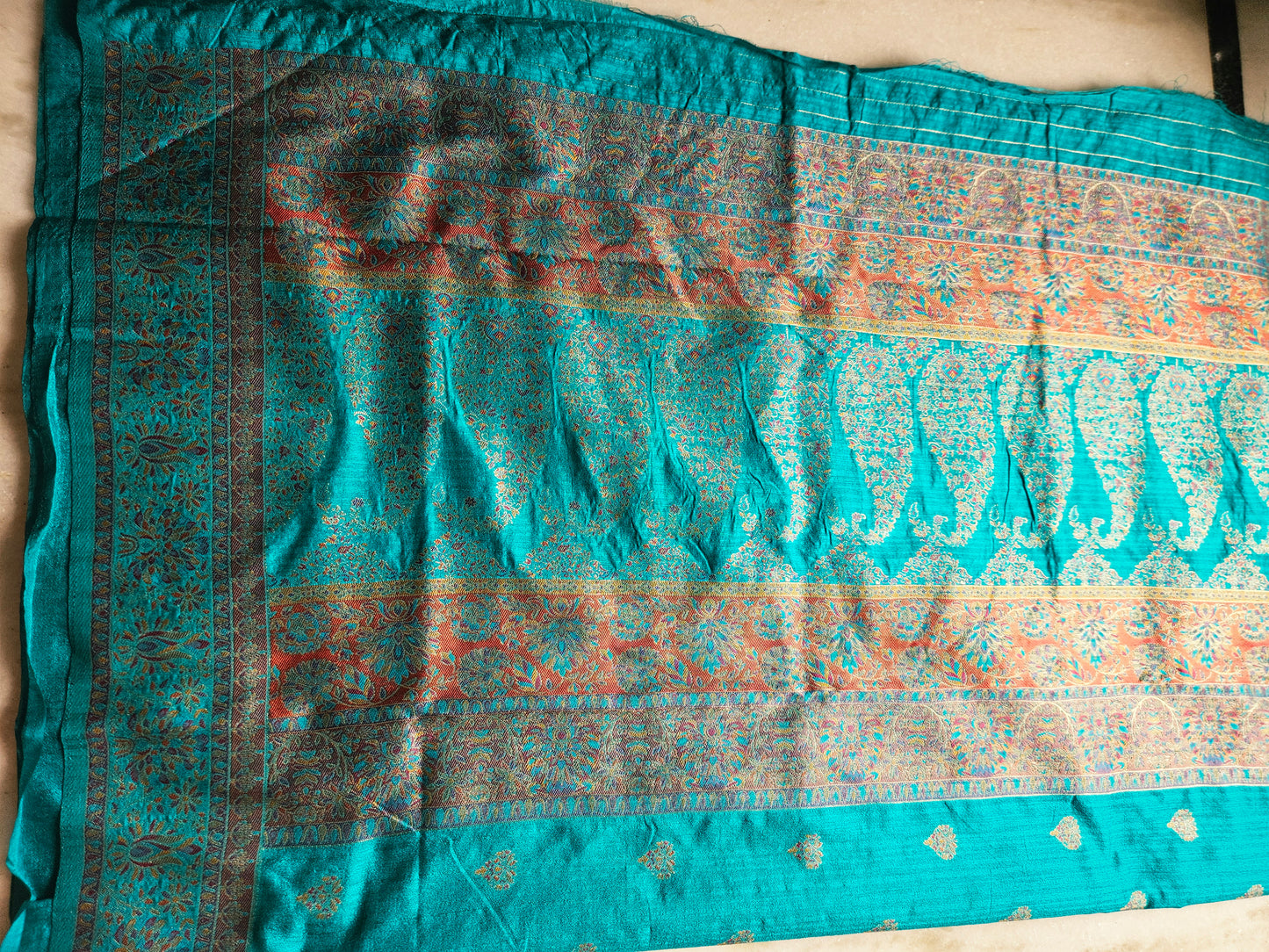 Premium Khaddi Silk Saree in Turquoise with Zari Buttis & Multicolor Kani Border