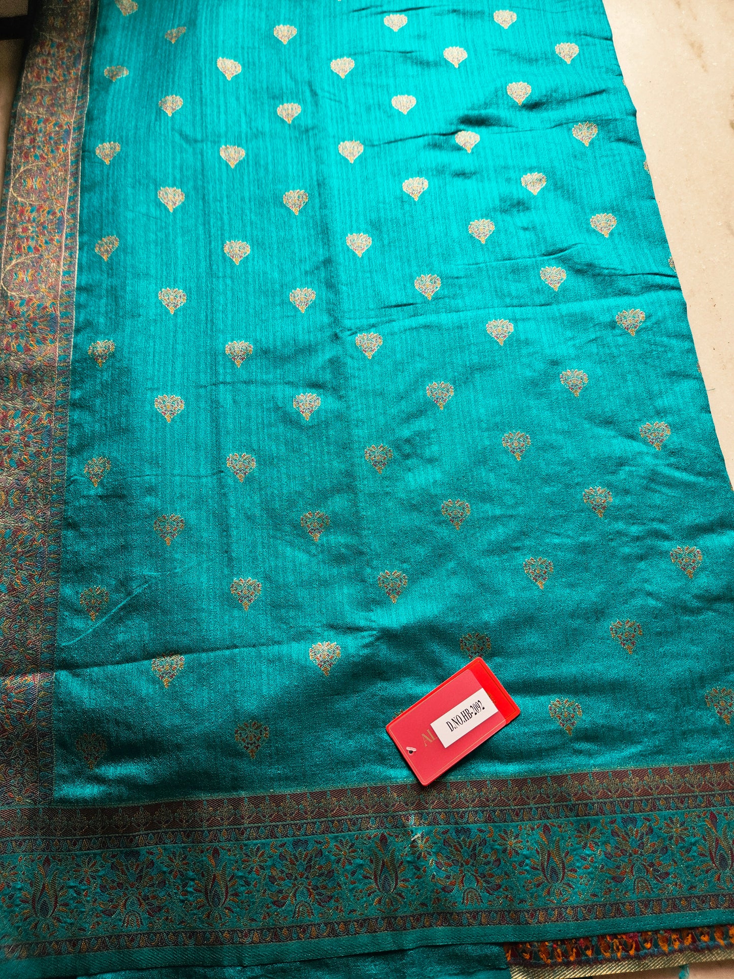 Premium Khaddi Silk Saree in Turquoise with Zari Buttis & Multicolor Kani Border