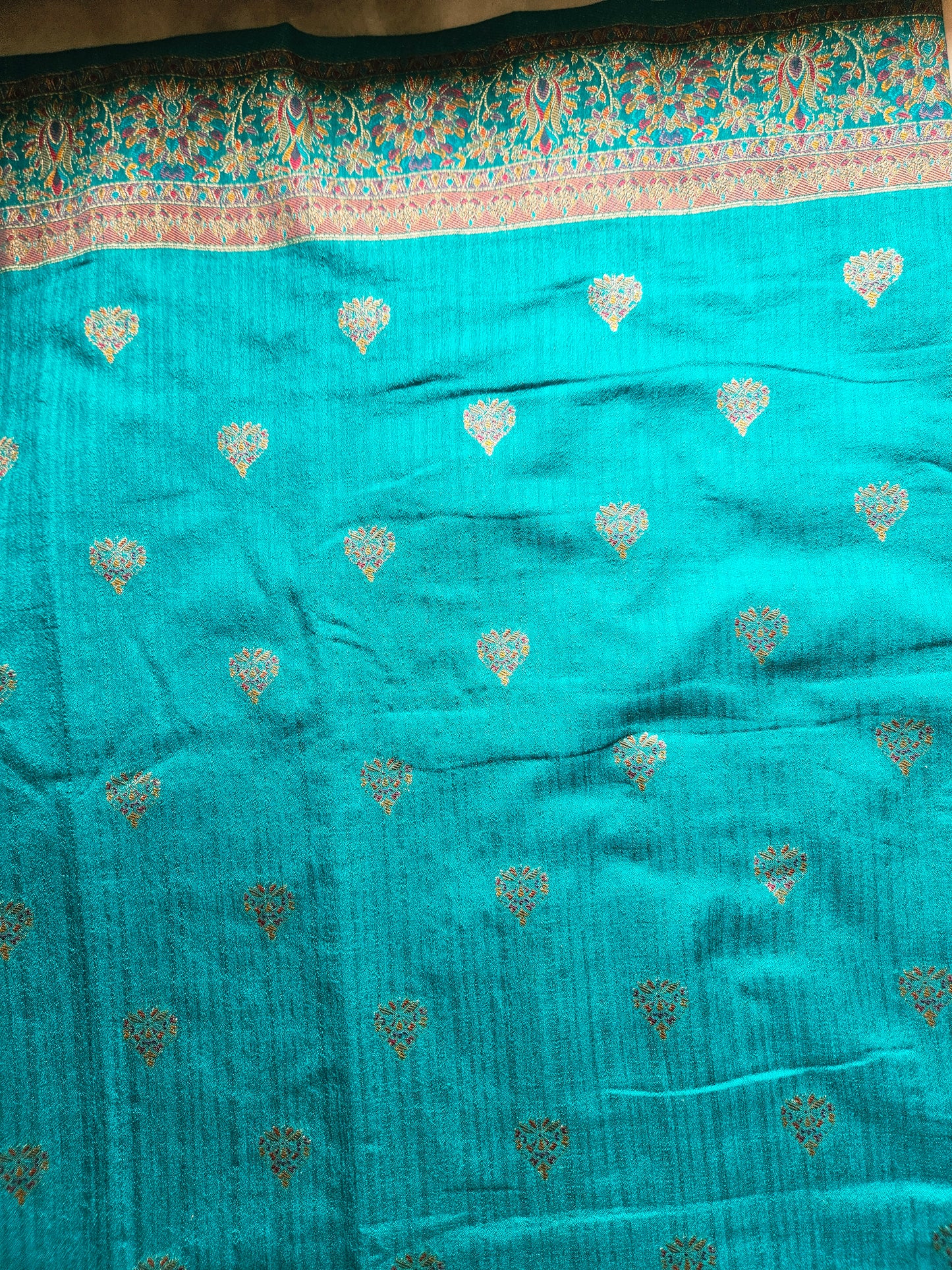 Premium Khaddi Silk Saree in Turquoise with Zari Buttis & Multicolor Kani Border