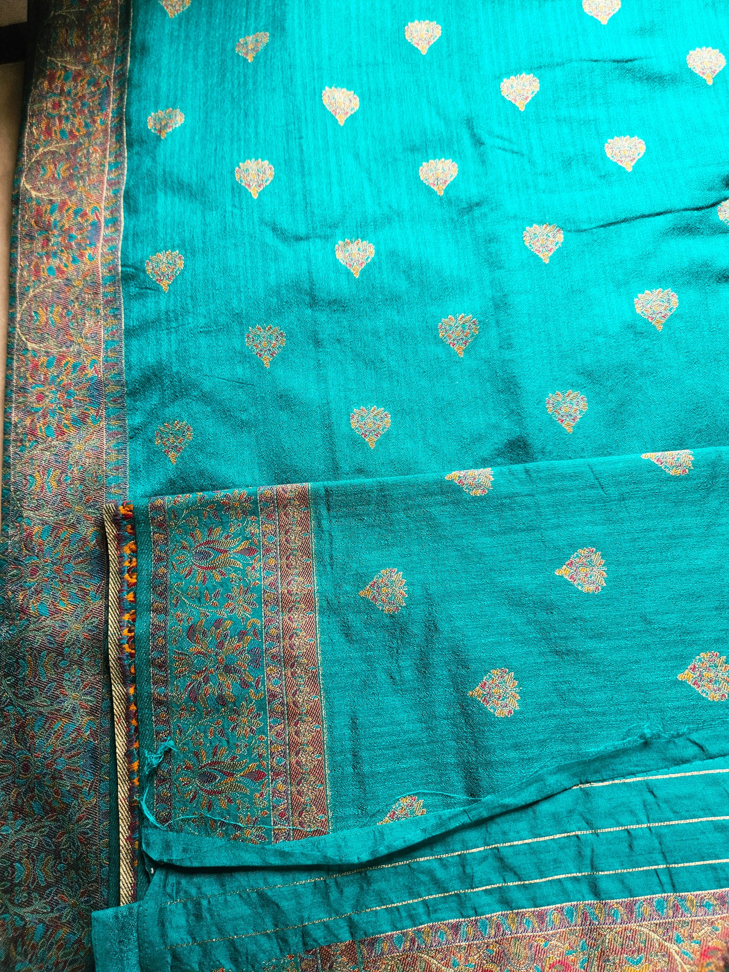 Premium Khaddi Silk Saree in Turquoise with Zari Buttis & Multicolor Kani Border